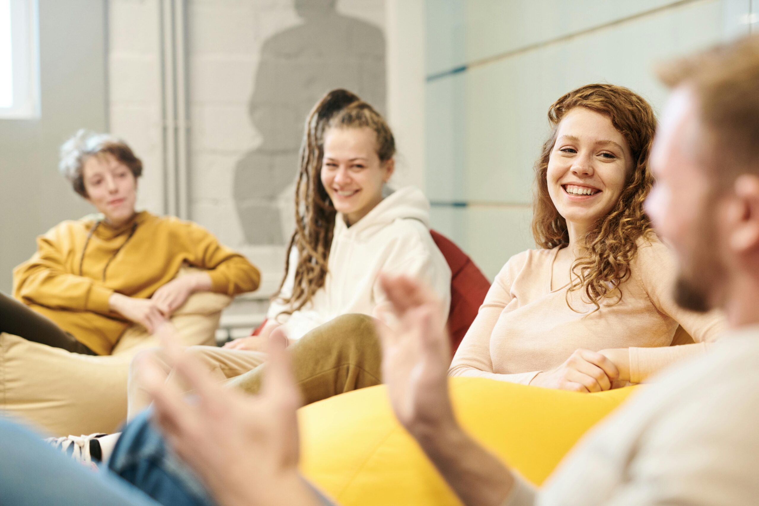 Group of people discussing ideas, building atomic habits in their organization.