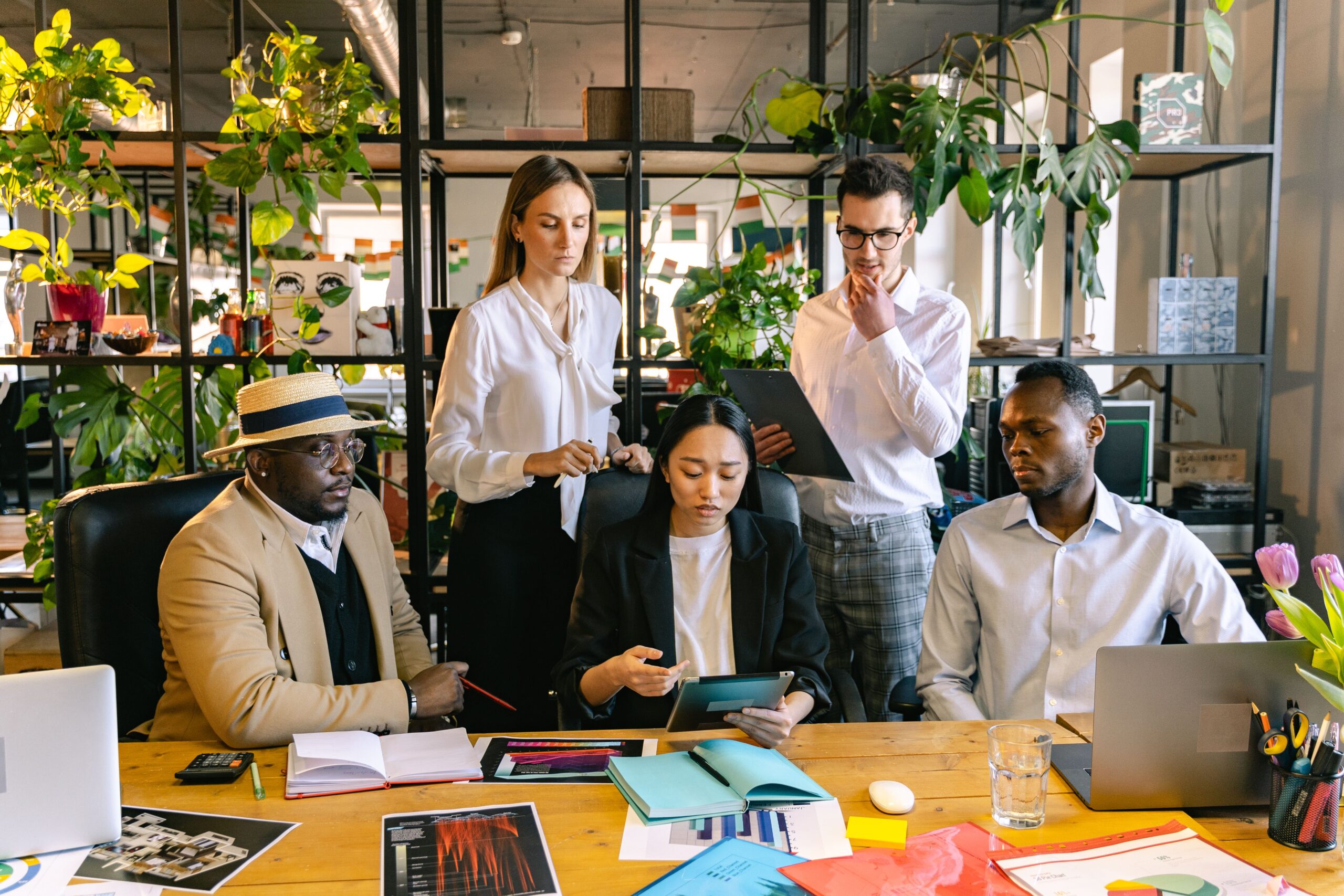 Diverse business team discussing legislative compliance in modern office