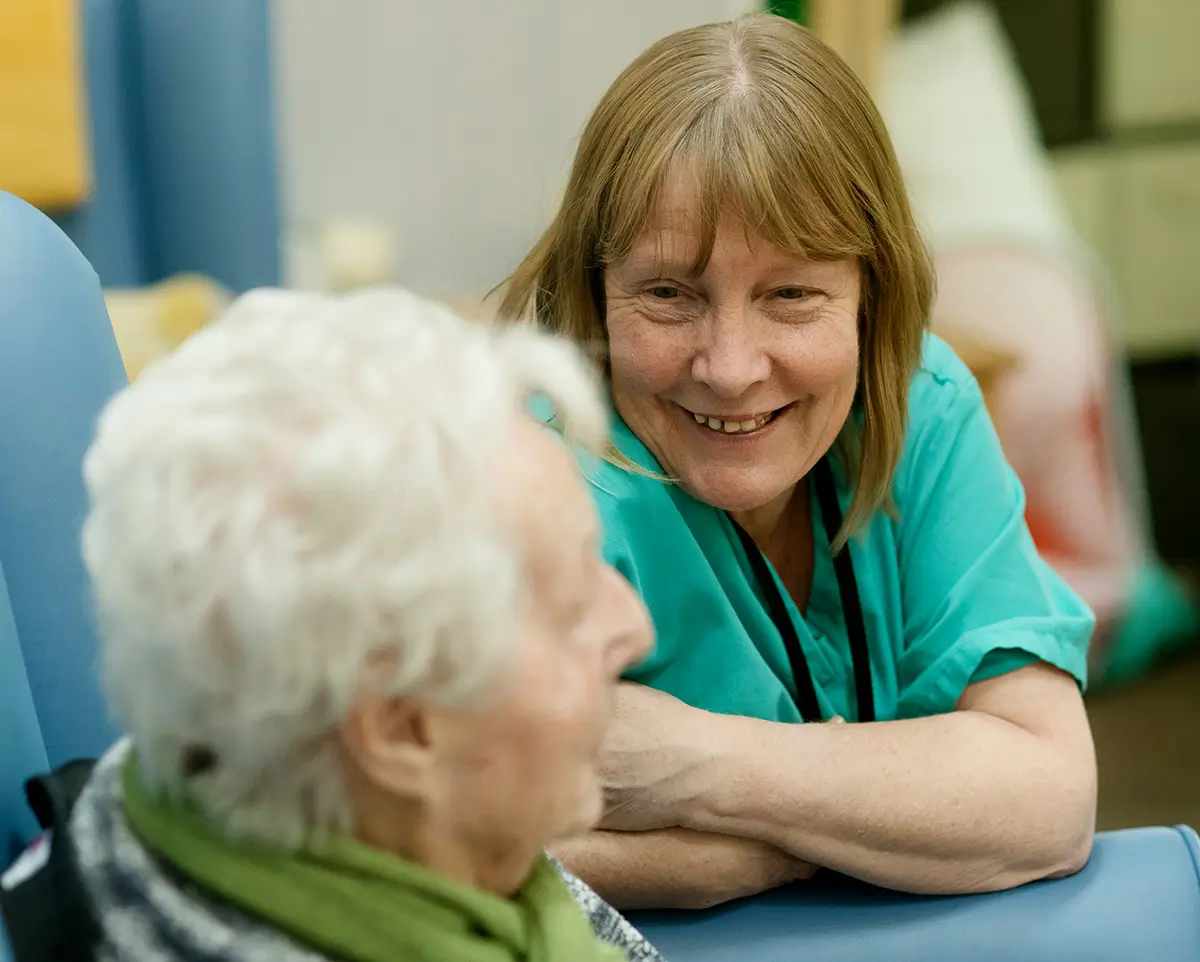 An aged care worker talking with an elderly person