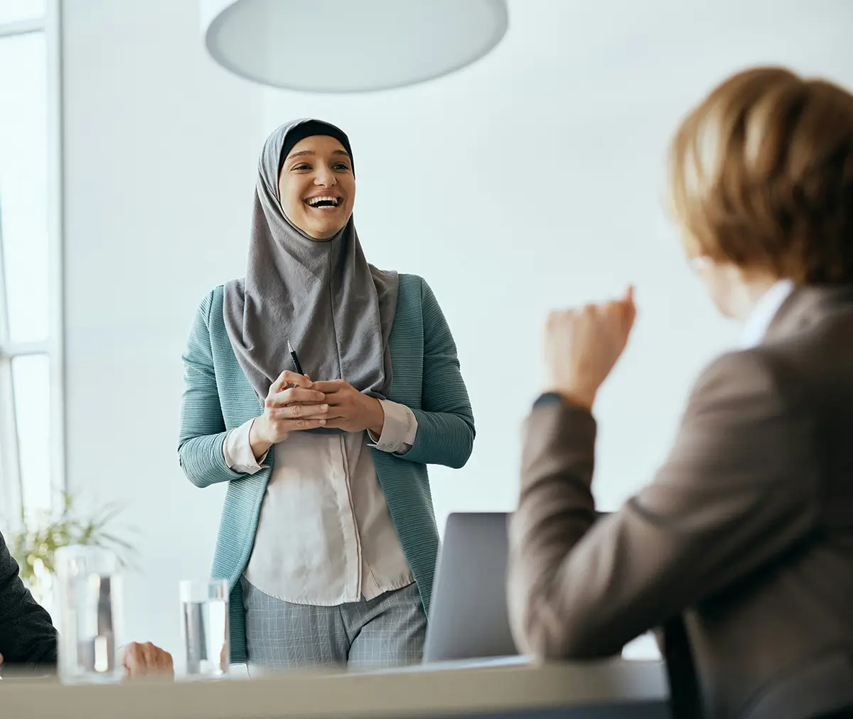 Two people happily talking together in a meeting room