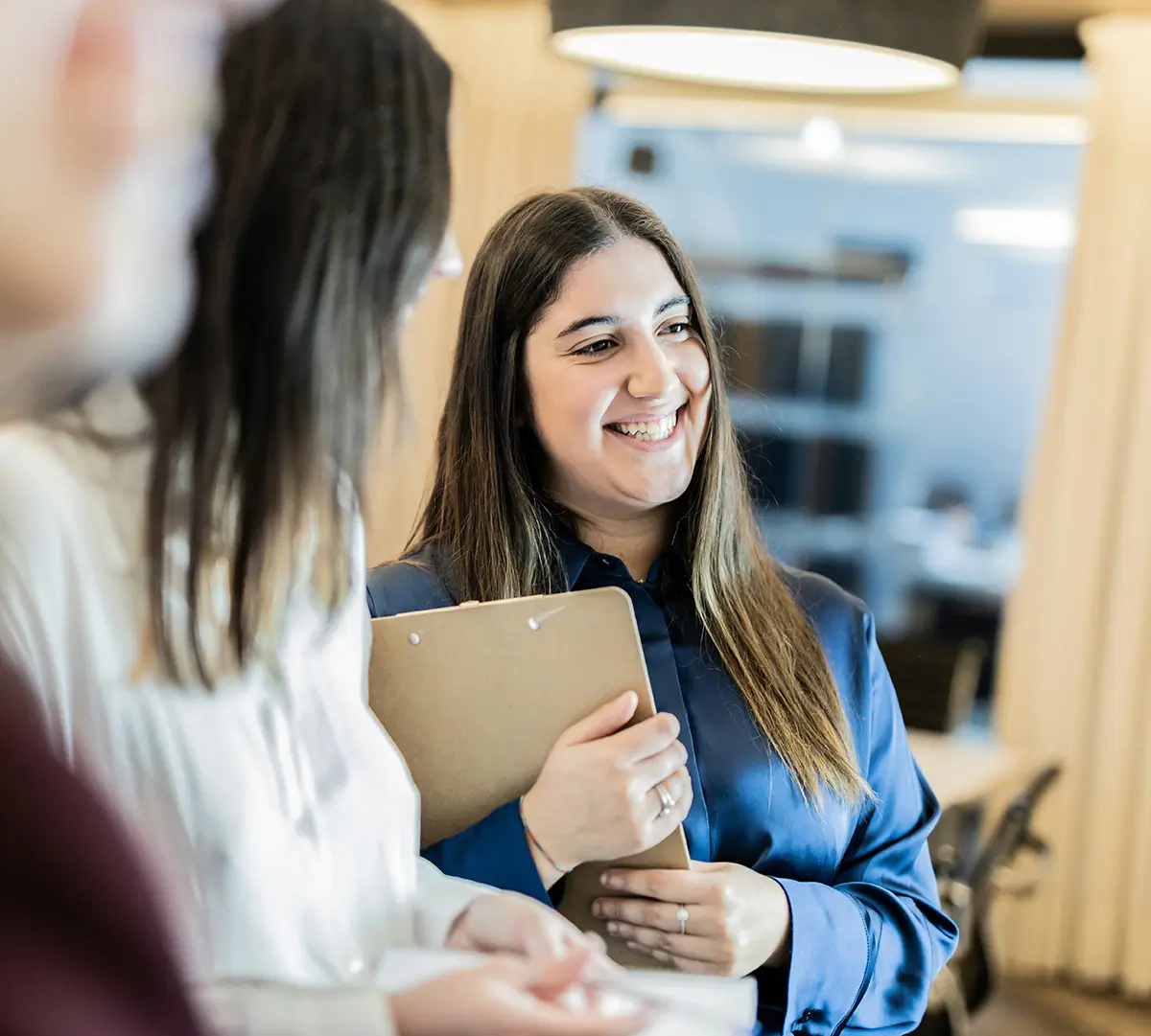 A person smiling, as if they are happy and confident with a full set of accreditation or audit ready policies