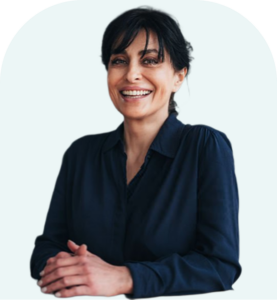 Professional woman with dark hair smiling confidently, hands clasped