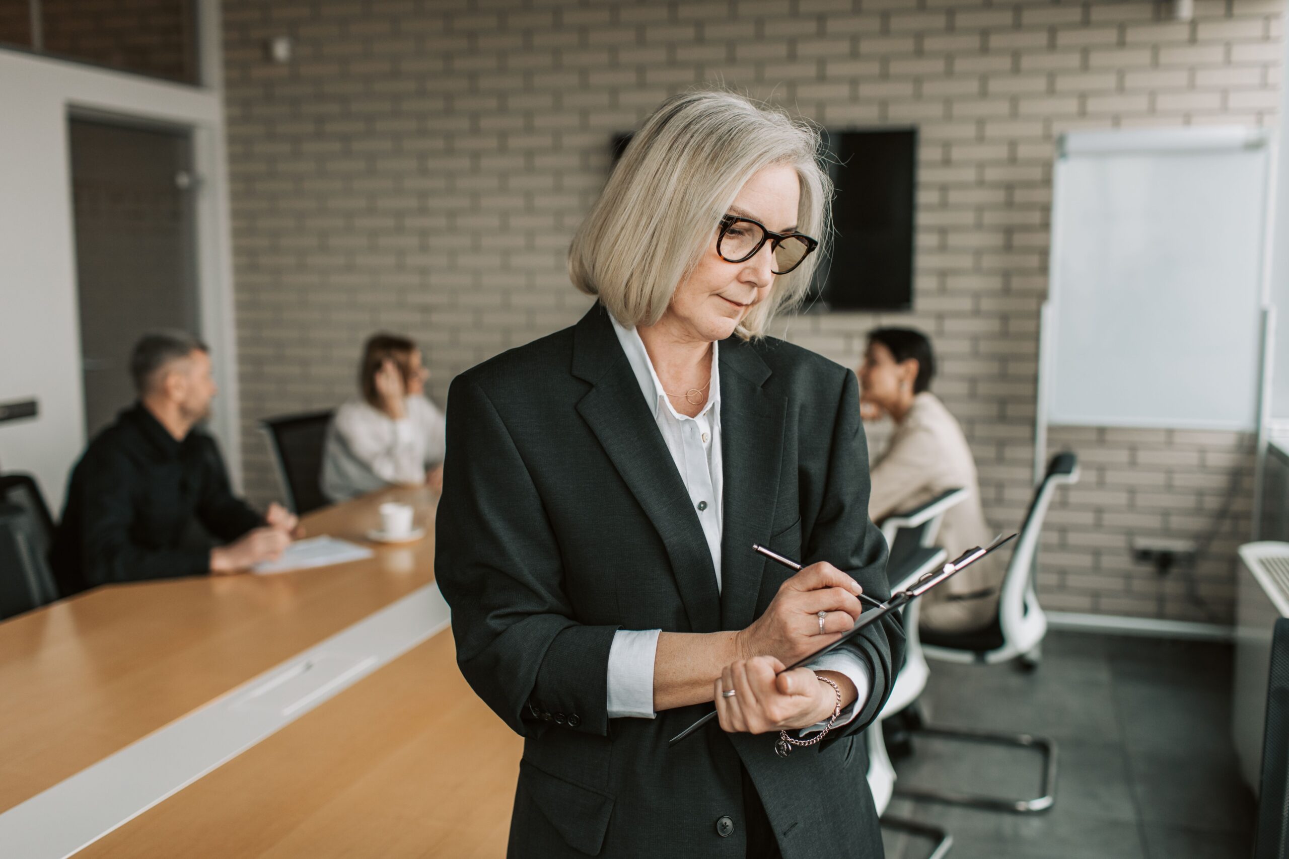 Businesswoman reviewing community services policies and procedures in meeting